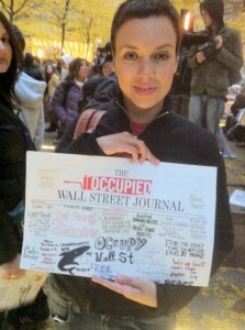 Photo of Mariné Pérez with the fourth edition of Occupy Wall Street Journal, taken by Chris Theokas.