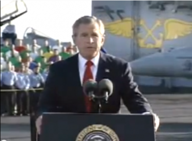 Controversial speech by George W. Bush, declaring the retreat of troops from Iraq. The famous sign "Mission accomplished" was hanging from the aircraft carrier. By then, the war was ongoing. Image taken from a video on YouTube.